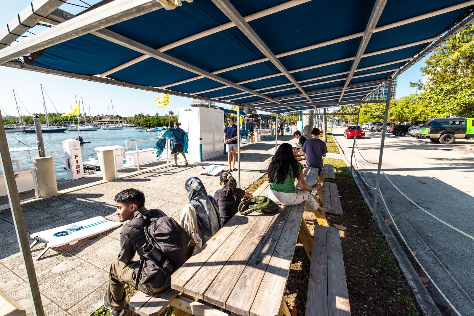 Guests waiting in the shaded seating area at the dock