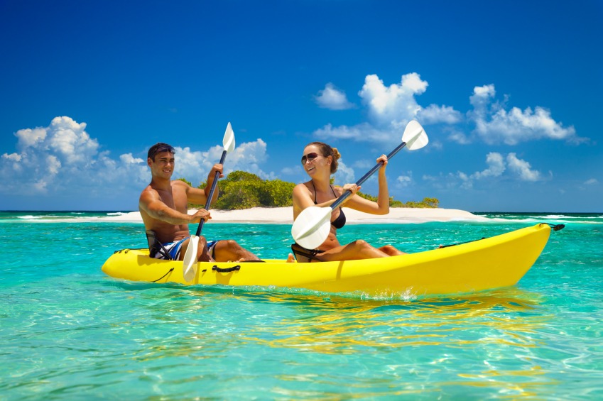 Couple kayaking in clear water with kayak rental